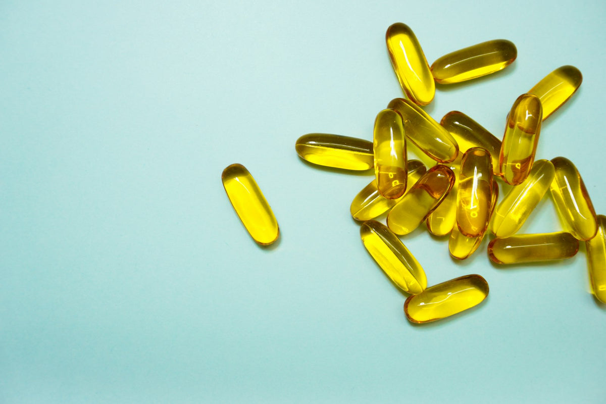 Two different types of vitamin capsules side by side, illustrating vitamin D2 versus D3